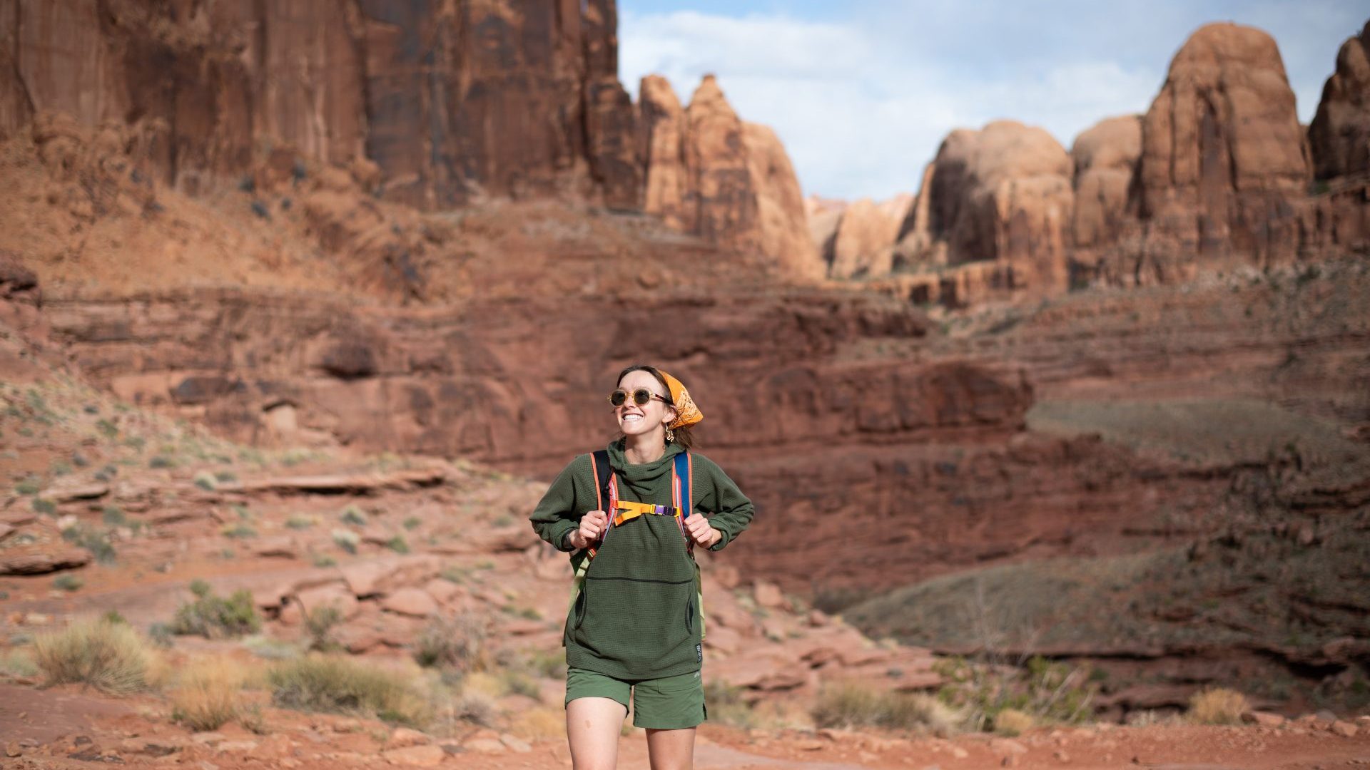 Woman wearing green hikes in red rock landscape