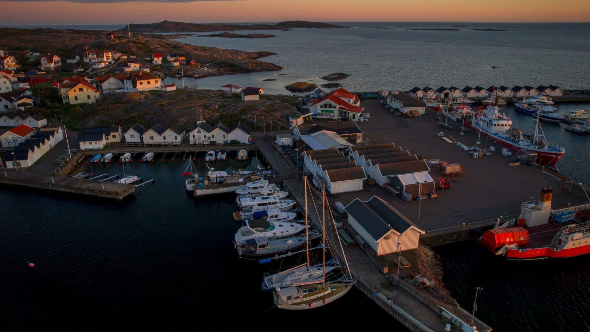 Drone shot at sunset hour of coastal village.