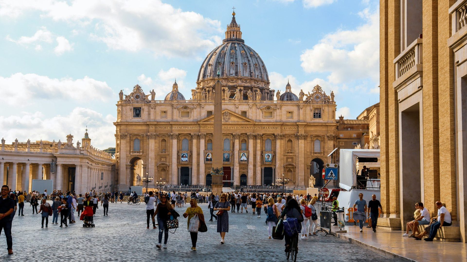 Small crowd approaches golden ornate building