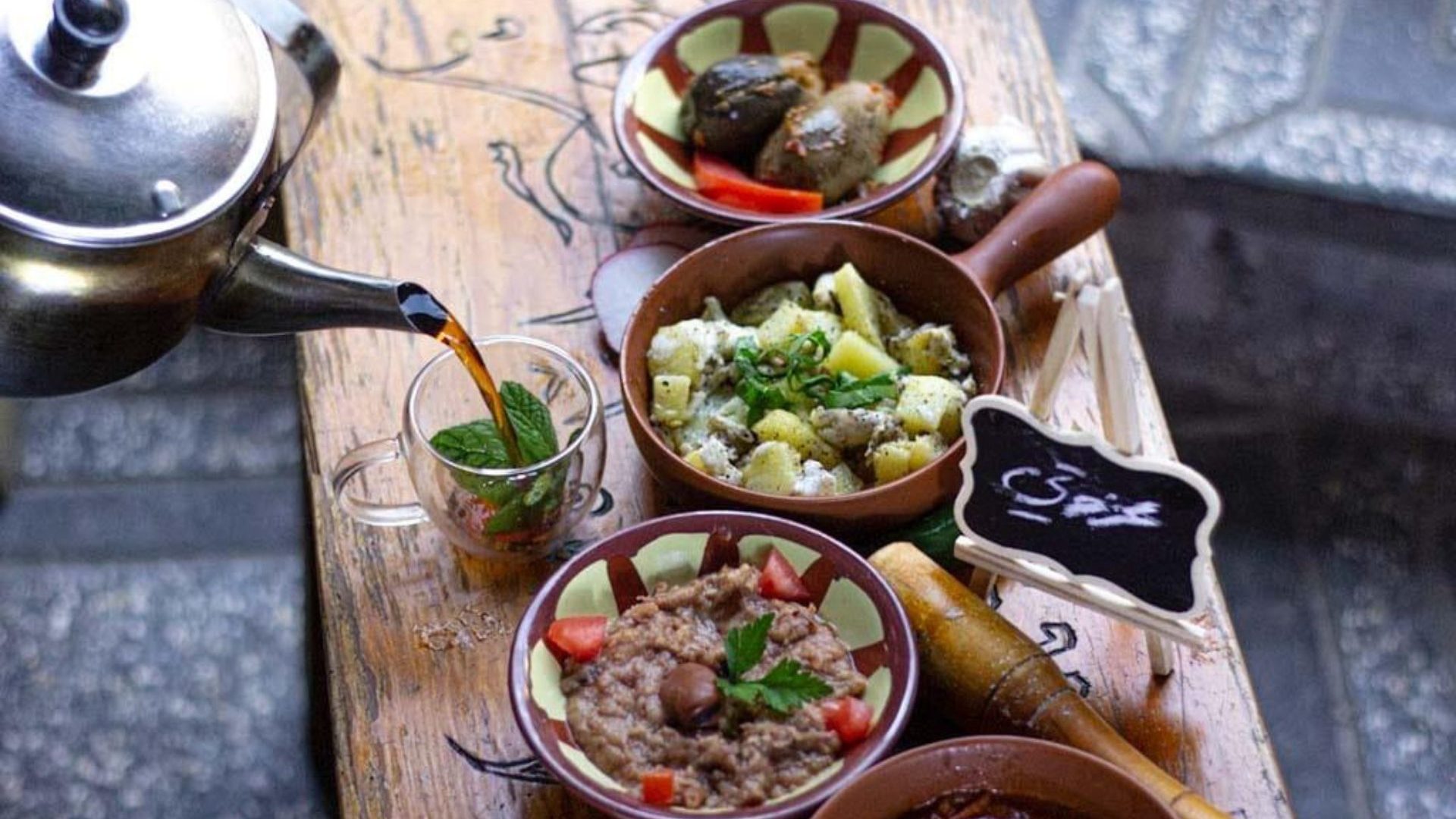 Wooden table lined with dishes