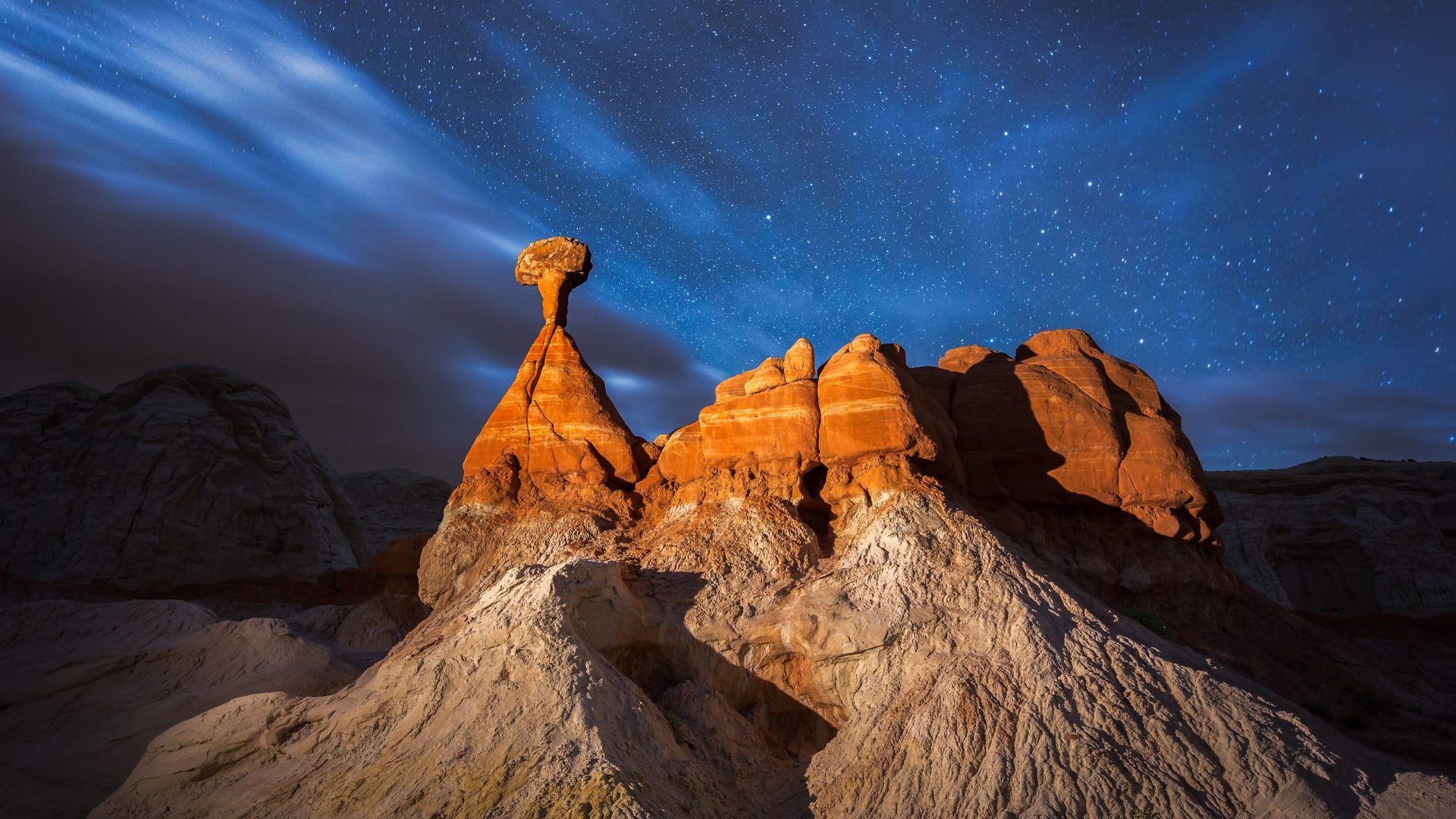 Red rock cliffs under night sky
