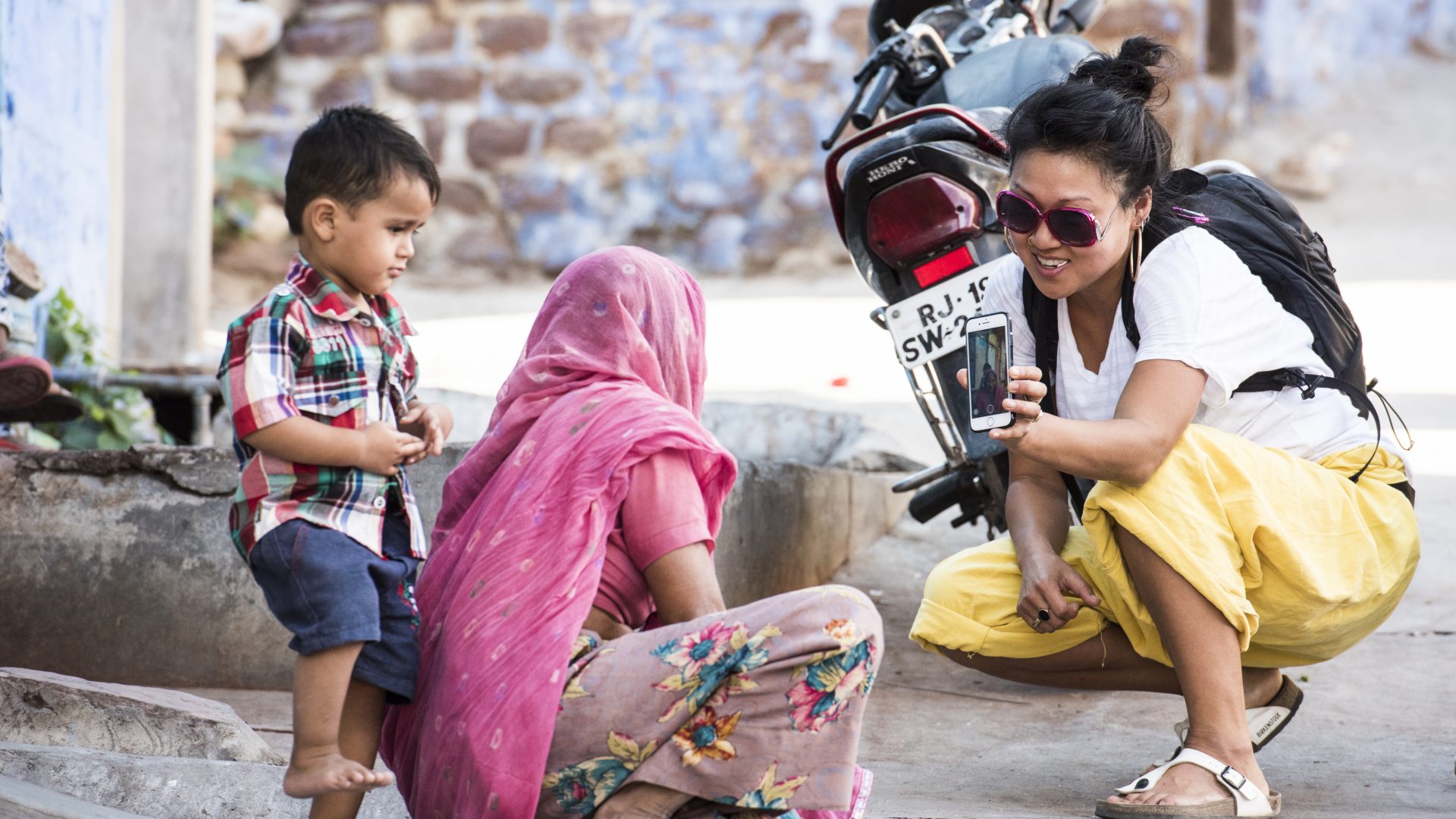 Responsible photography: A tourist shows off the photos she has just taken of a woman and her child.