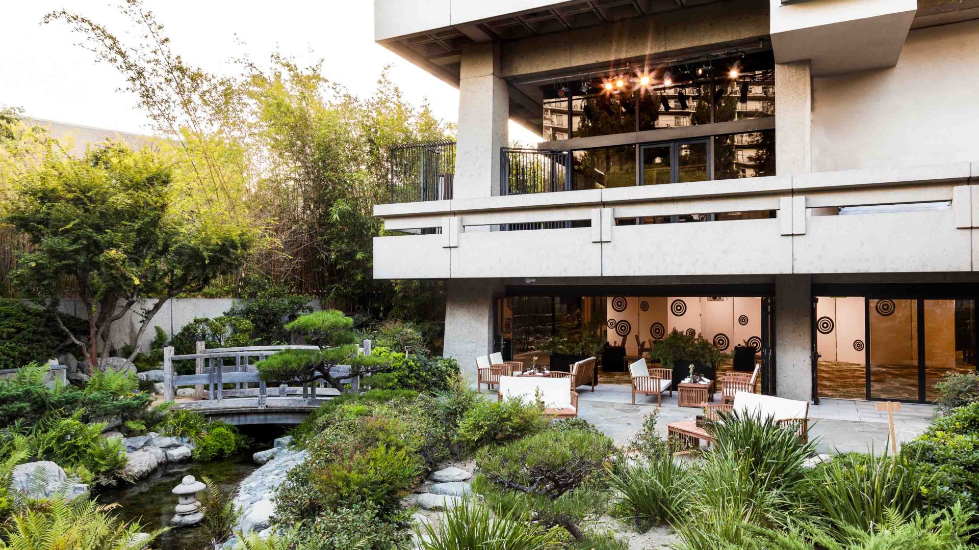 The exterior of a building set in green gardens.