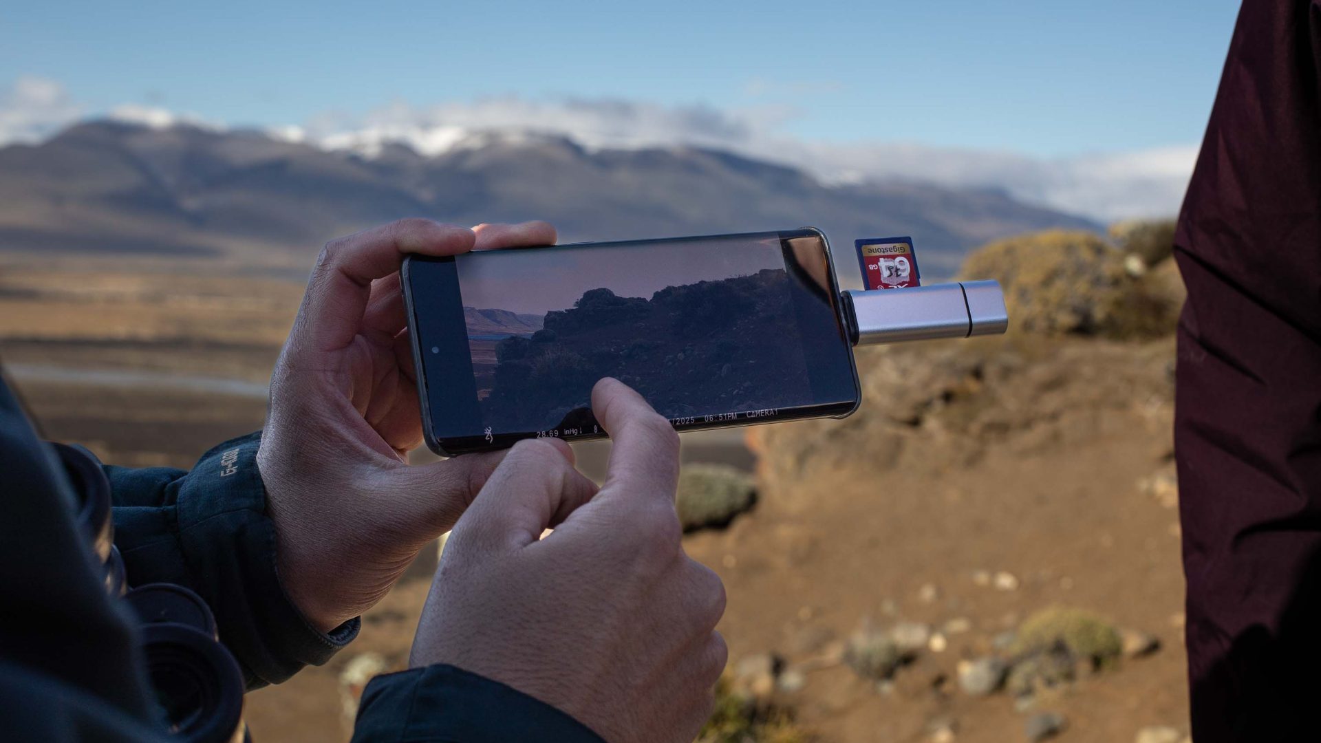 A person imports data to a phone using a USB stick.