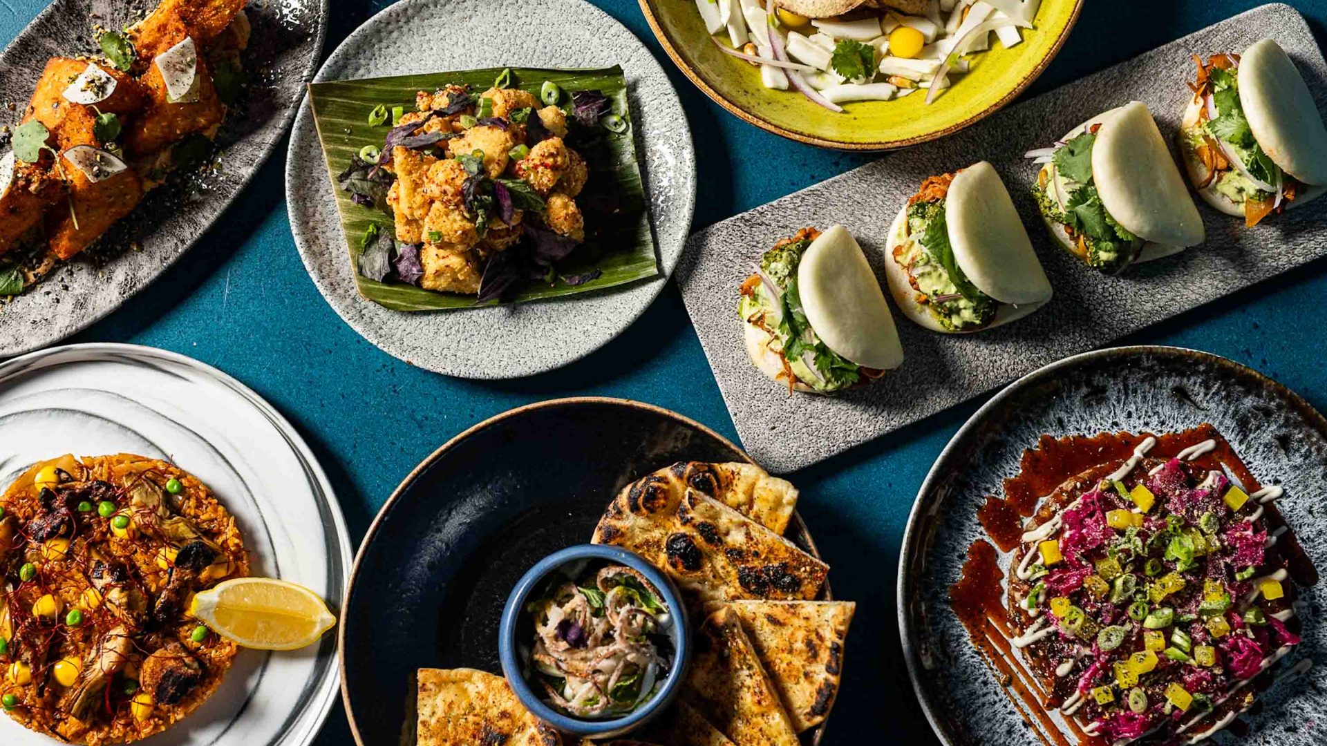 A table laid out with various dishes of food.